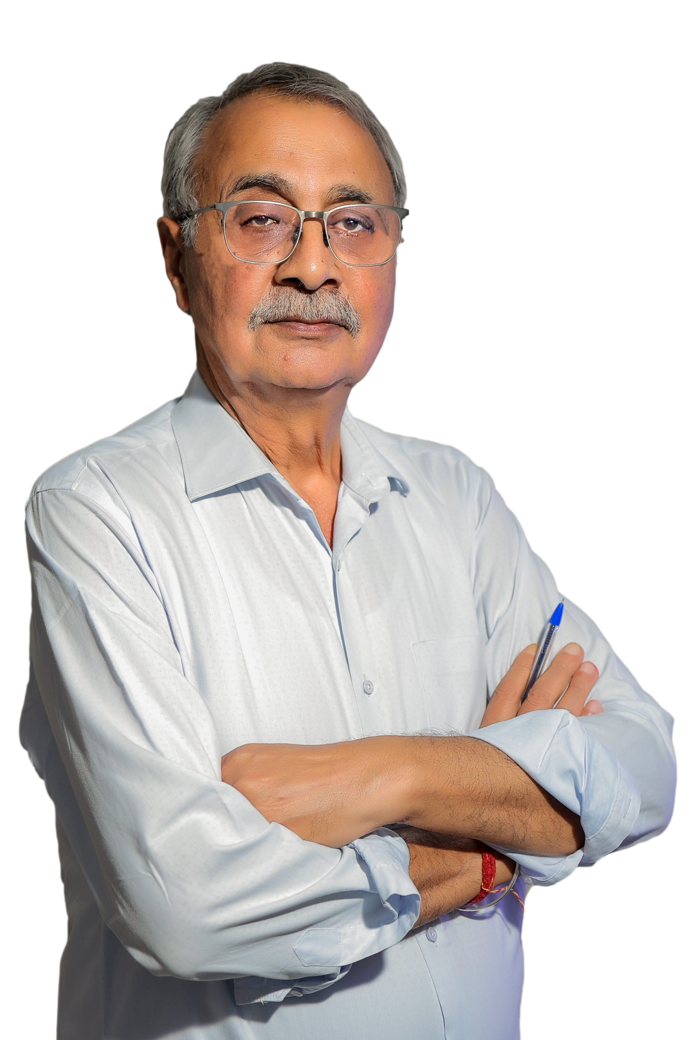 Technician operating the controls of a GE MRI machine with a patient inside.